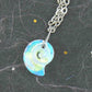 15-inch necklace with 15mm iridescent clear swirl shell Swarovski crystal pendant, stainless steel chain