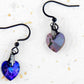 Short earrings with 10mm faceted Heliotrope (deep blue and violet) Swarovski crystal hearts, black stainless steel hooks