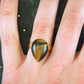 Finger ring with drop-shaped golden tiger eye stone cabochon, gold-toned hypoallergenic stainless steel adjustable base (US 7-8)