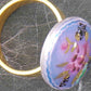 Finger ring with hand-painted blue-pink-gold-black oval vintage glass cabochon, abstract flower pattern, gold-toned stainless steel adjustable base