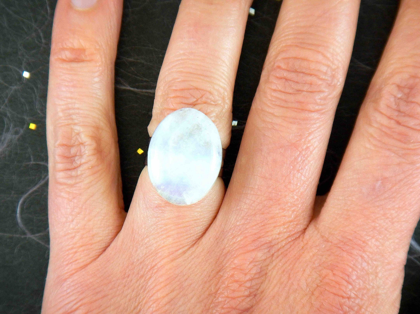 Finger ring with large natural white oval moonstone cabochon, stainless steel adjustable base (US 5-6)