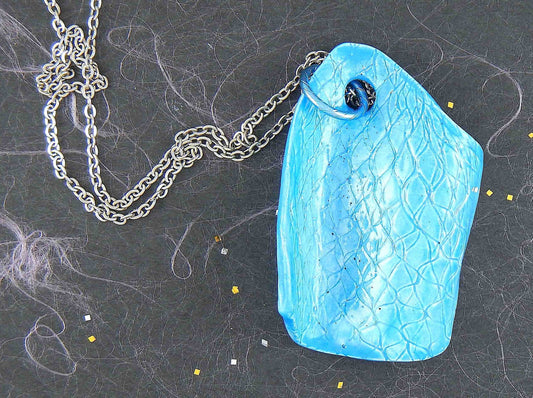 22-inch necklace with large textured bright turquoise wave ceramic pendant handmade in Montreal, stainless steel chain