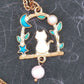17-inch necklace with tiny enamelled white cat sitting on a branch, blue moon and star, pearl detail, rose gold-toned stainless steel chain