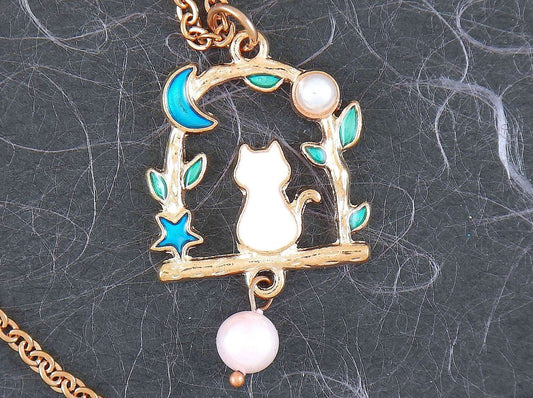 17-inch necklace with tiny enamelled white cat sitting on a branch, blue moon and star, pearl detail, rose gold-toned stainless steel chain