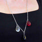 Collier 28 po avec montage asymétrique de 3 gouttes de verre (rouge translucide, noir opaque, clair irisé), chaîne acier inoxydable