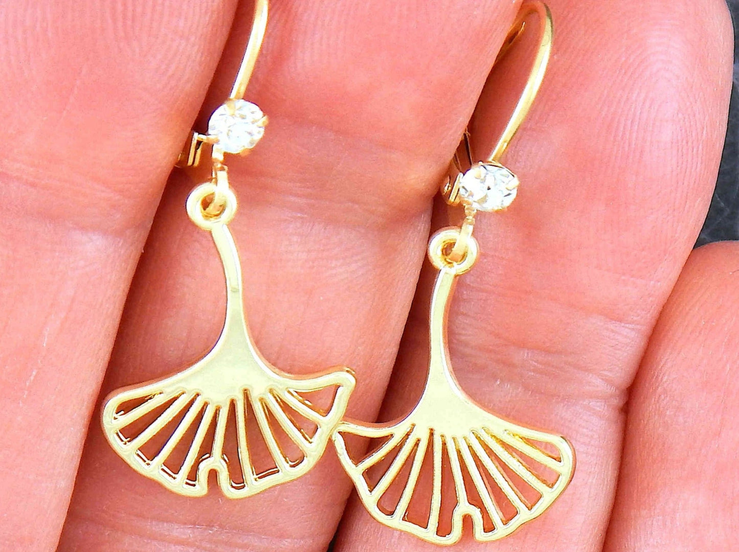 Short earrings with delicate golden ginko tree leaves, gold-toned stainless steel lever back hooks with tiny clear Swarovski crystals