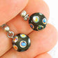 Short earrings with small shiny black round Czech glass pebbles, small multicoloured dots, stainless steel posts