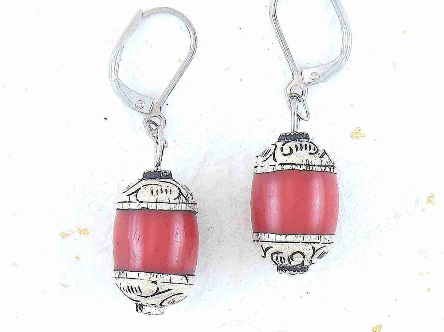 Short earrings with red resin and pewter Tibetan cylinders, sculpted caps, stainless steel lever back hooks