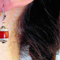 Short earrings with red resin and pewter Tibetan cylinders, sculpted caps, stainless steel lever back hooks