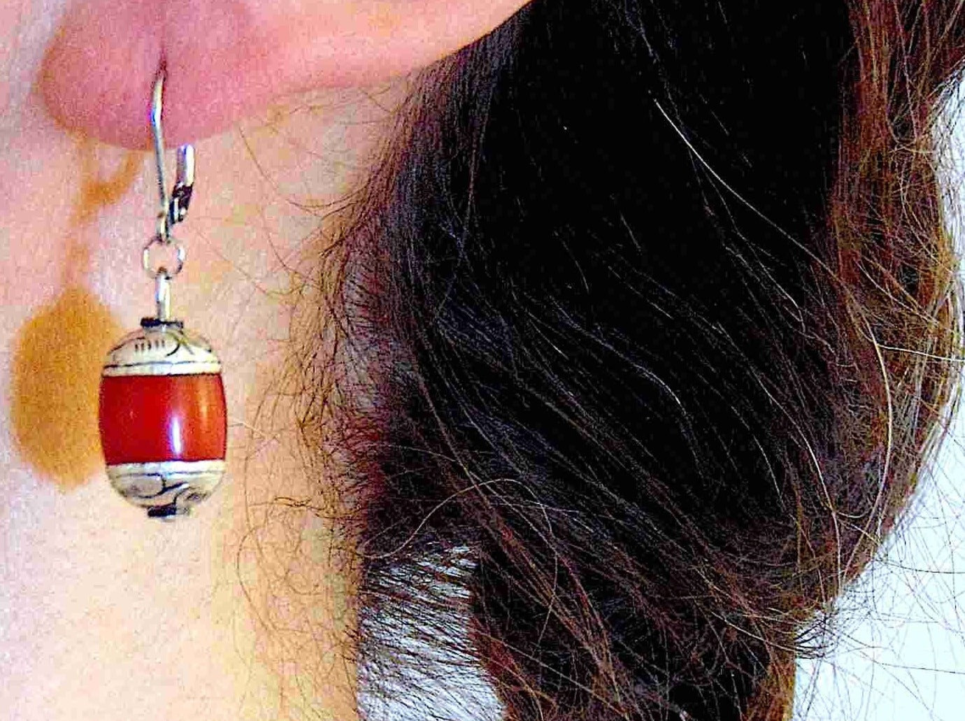 Short earrings with red resin and pewter Tibetan cylinders, sculpted caps, stainless steel lever back hooks