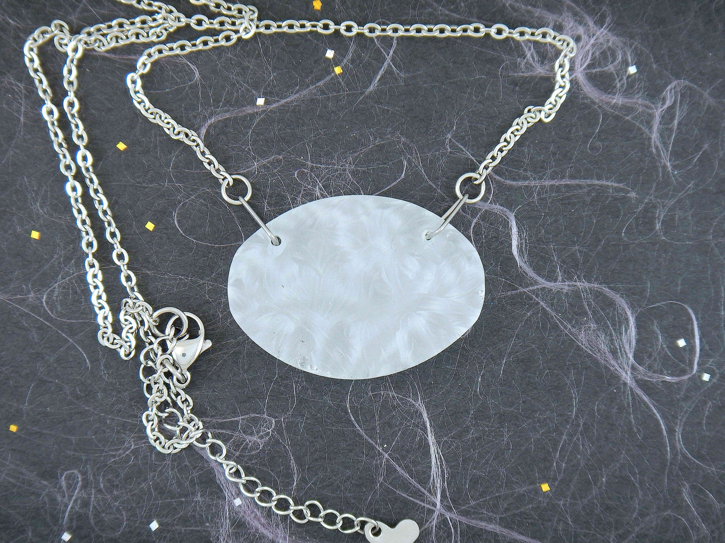 18-inch necklace with large oval matte vintage crystal pendant, sculpted on both sides (Lalique-style flower and leaf pattern), stainless steel chain