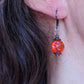 Short earrings with intense iridescent orange vintage glass raspberry beads, black nickel metal lever back hooks