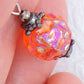 Short earrings with intense iridescent orange vintage glass raspberry beads, black nickel metal lever back hooks
